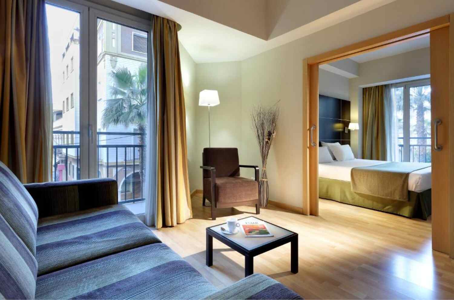 Junior suite lounge with balcony at Dorma Tartessos